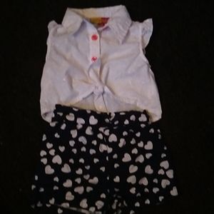 White top and navy shorts with hearts